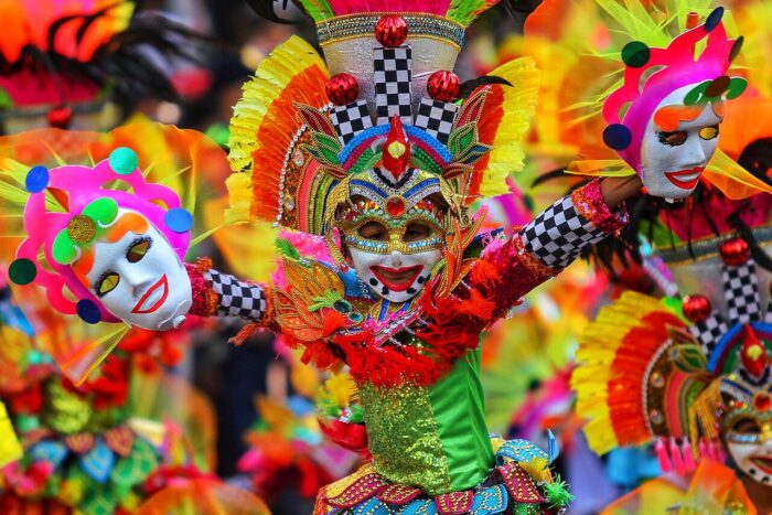 Kid in Masskara photo by Herbert Kikoy via Wikimedia Commons