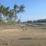 A woman in Sibunag carries buckets of water for her family