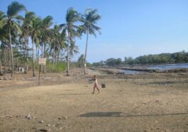 A woman in Sibunag carries buckets of water for her family