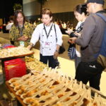 A young regional chef explaining eastern visayan cuisine ingredients to journalists at 2016 Madrid Fusion Manila