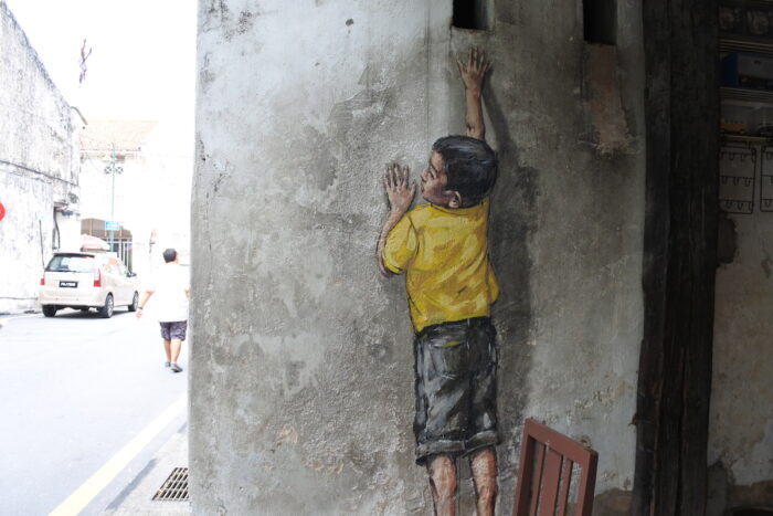 Little Boy Reaching Up by Ernest Zacharevic in Lebuh Cannon