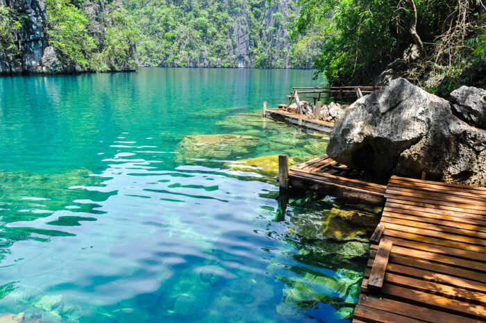 Very Clean and Clear Kayangan Lake next to a wooden path