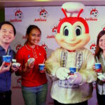 Jollibee brings truly #PinoyAndProud flavors this June! With Jollibee wearing the Barong Tagalog, (from left) Jollibee Brand Manager for Yum! Burger, Mathew Whang, Brand PR and Engagement Manager Cat Trivino, and Brand Communications Director and Head of Kids Marketing Arline Adeva holds up their newest offerings: Adobo Flakes Yum! Burger and Halo-Halo Sundae.