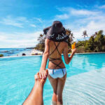 Murad Osmann's hand is stretching out after his wife Natalie Zakharove, who is leading the way to the beautiful infinity pool of Amorita Resort in Panglao Island Bohol