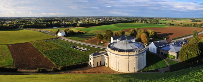 Panoramic view of the wide open fields where the battle took place taken from the top of the Lion’s Mound with the round theater in the foreground.