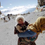 A Tibetan pilgrim is circling sacred Namtso Lake