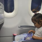 On her seat, prior to take-off