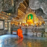 A praying Monk inside Wat Srisuphan