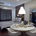 A wide view of the bed and dining area