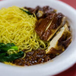 Chan Hong Meng's soya sauce chicken noodle at Chinatown Complex on July 24, 2016 in Singapore. Chan was awarded a one-star rating by Michelin on July 21, making him one of the first street food hawkers to be awarded in the guide's history.