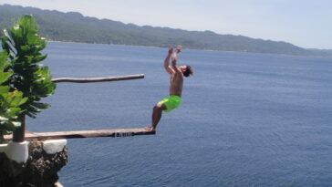 A commencing back-flip from the 9-meter board