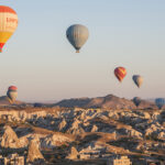 The wind lines them up above the outskirts of Goreme.