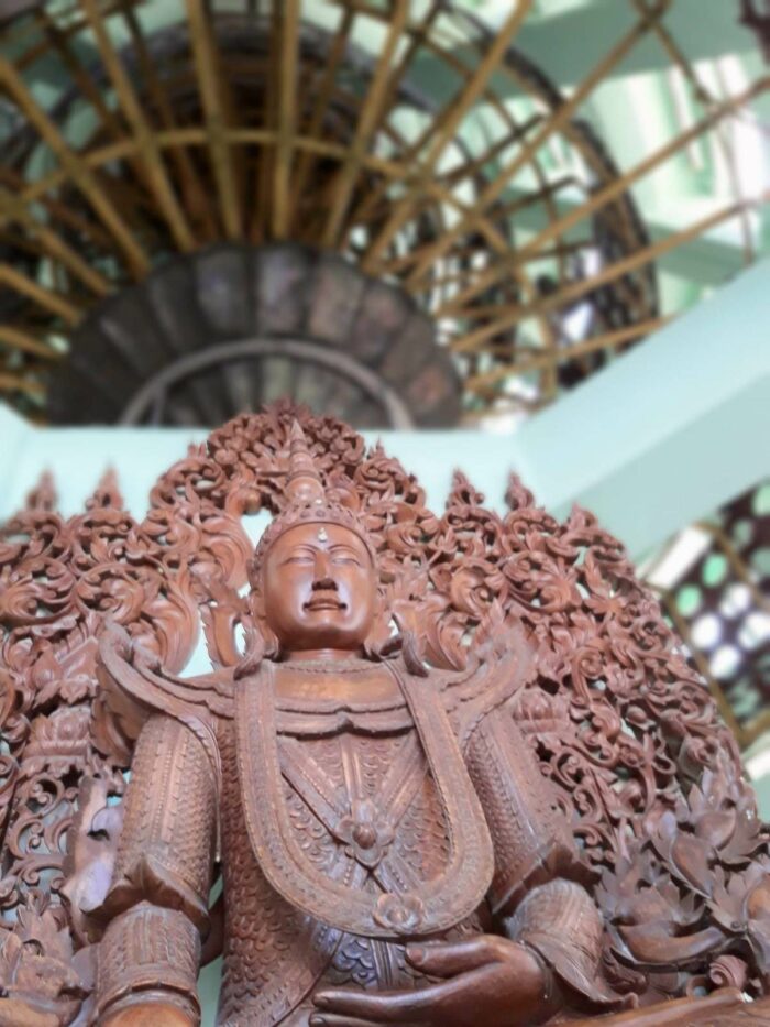 A wooden Buddha inside the Shwedagon Pagoda