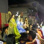 People are lining up to get closer to the image of the patron saint