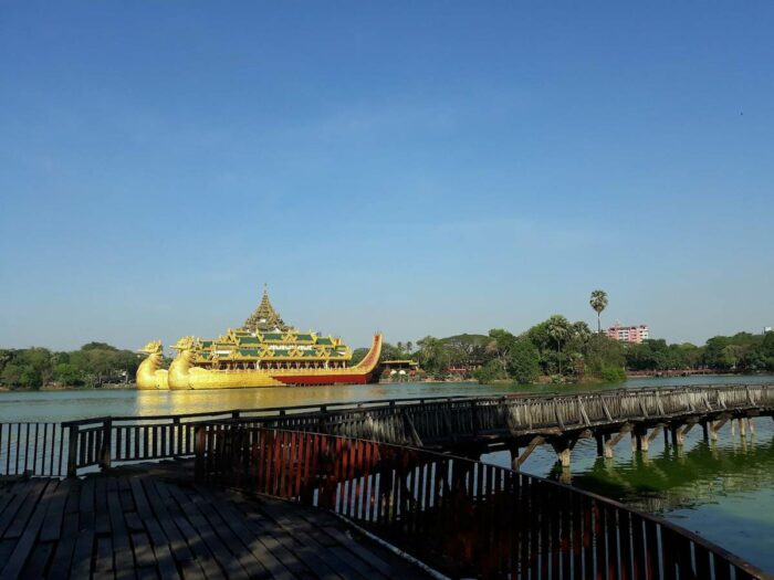 Walk in this this wooden bridge in Kandawgyi Park.