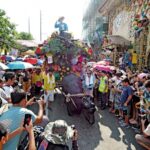 Kneeling Carabao in front of Festival goers