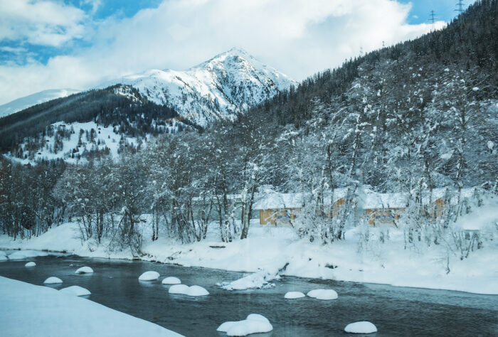 Ice floes on the river beneath the soaring Alps.