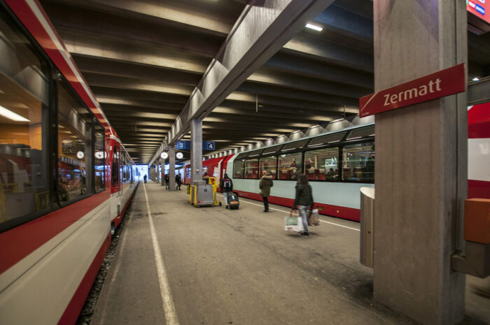 The local train on the left and the Glacier Express on the right preparing to leave Zermatt station.