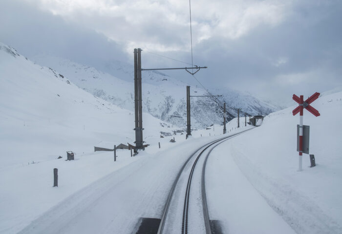 The railroad track slices through the whiteness of the freshly-fallen snow.