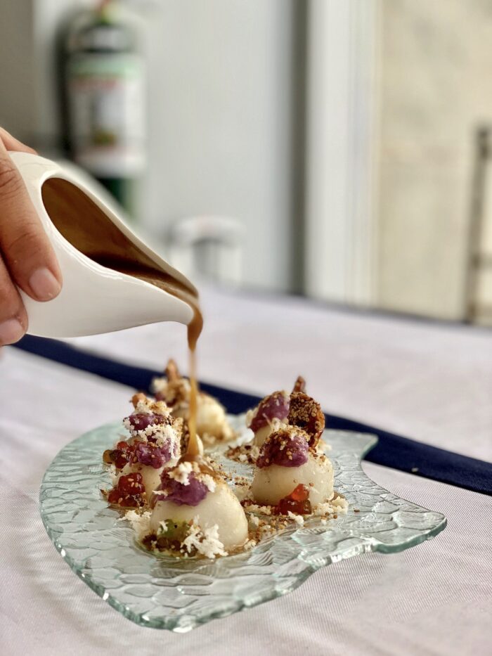 Rice cake patty filled with locally candied fruits, coconut reduction and topped with ube halaya