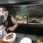 Action shot of the young chef (barely) grilling our steaks