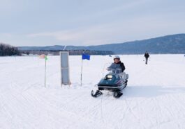 Driving a snowmobile around frozen Lake Akan