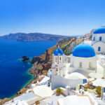 Architecture of Oia village on Santorini island photo via Depositphotos