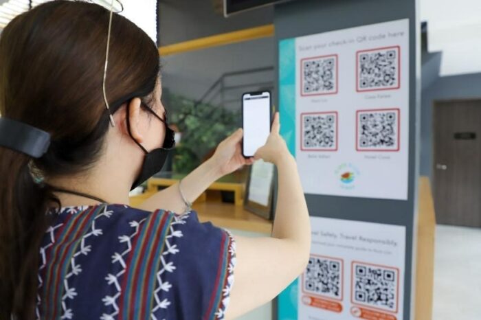 Tourism Secretary Puyat scans a Quick Response (QR) code for check-in procedures as tourism establishments adapt to digitalization and new normal