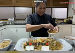 International Chef Margarita Forés, owner of such restaurants as Cibo and Grace Park, adds the finishing touches to her own version of Hokkien Mee by topping it with generous amounts of crispy fish.