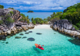 Aerial drone view of in kayak in crystal clear lagoon sea water during summer day near Koh Lipe island in Thailand photo via Depositphotos