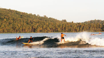 Surfing in Nias photo via Depositphotos