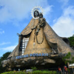 Regina Rica Rosarii statue facade photo via Depositphotos