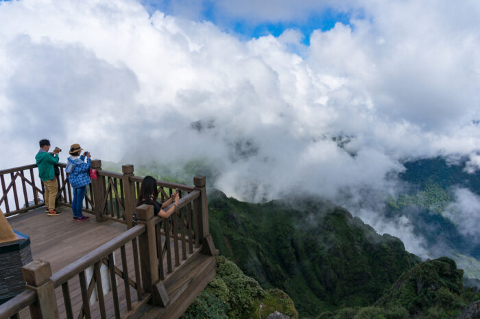 Tourists enjoying the view from observation deck on Fansipan Mountain photo via Depositphotos
