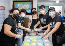 Starbucks partners helping in the Kusina ng Kalinga kitchen, packing nutritious meals for 300 kids.