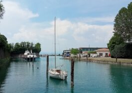 A glimpse of Lago di Garda beyond the docked boats