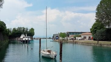 A glimpse of Lago di Garda beyond the docked boats