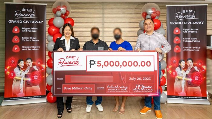 (From L to R) Cheryl Maxine P. Loyola, AVP and Head, PLDT Home Marketing PR, 5-Million PLDT Home Rewards 2022 Grand Giveaway Promo Winner, Partner of 5-Million PLDT Home Rewards 2022 Grand Giveaway Promo Winner, Jason Ignacio, AVP and Head, PLDT Home Loyalty and Planning