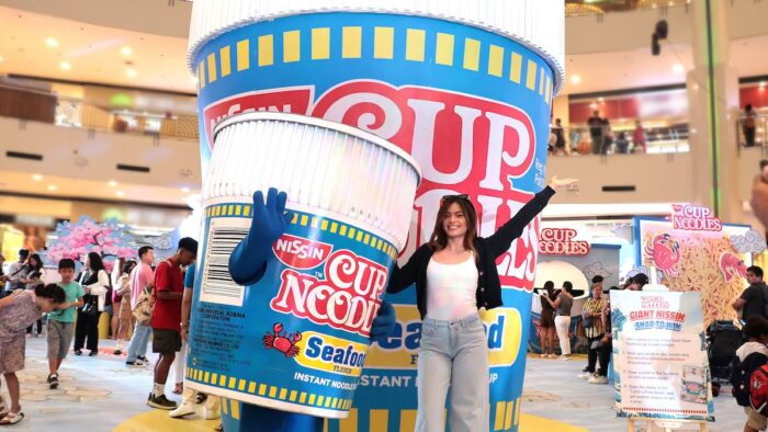 Professional volleyball player Jen Nierva posing with Nissin Cup?Noodles’ “Cup Man” mascot?