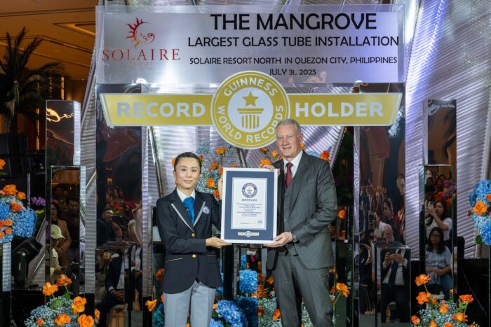 (From L-R) Official GUINNESS WORLD RECORDS™ Adjudicator, Emi Saito, with Bloomberry Resorts Corp. President and Chief Operating Officer, Gregory Hawkins holding the official certificate for The Largest Glass Tube Installation