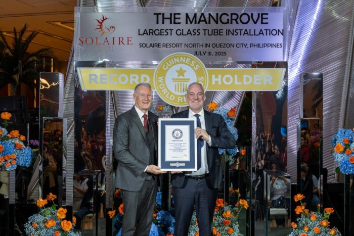 (From L-R) Bloomberry Resorts Corp. President and Chief Operating Officer, Gregory Hawkins and Solaire Resort North Chief Operating Officer Damian Quayle holding the official GUINNESS WORLD RECORDS™ certificate for The Largest Glass Tube Installation