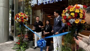 Michael Needham, Thai Ambassador Makawadee Sumitmor, Alex Offeand getting ready to cut the ribbon