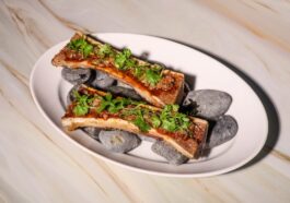 Fire-roasted beef bone marrow with nam tok tamarind vinaigrette, dried chili and in-house toasted rice cracker