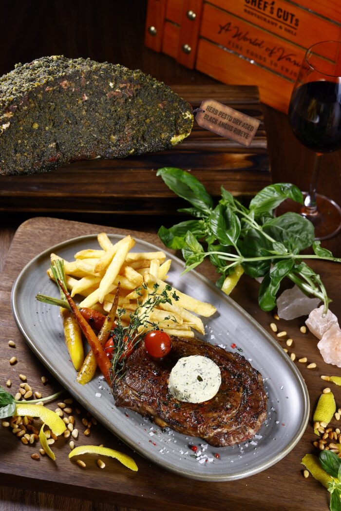 Herb Pesto Dry Aged Black Angus Ribeye with sides