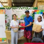 Domestic Promotions Department, Industry Relations and Services Division Chief Ms. Margarita P. San Jose hands over drybag and dryfit shirts to members of Dewil Mangrove Cooperative on behalf of the TPB