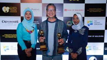 General Manager Den Navarro proudly holds Savoy Hotel Manila’s two World Travel Awards alongside the presenters at the 33rd World Travel Awards Gala Ceremony in Crossroads Maldives
