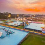 Colorful pools, playful inflatables, and exciting slides stretch across the park, offering visitors plenty of ways to cool off, have fun, and enjoy the vibrant atmosphere as the sun begins to set.