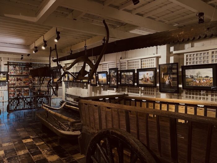 “Nawalang Kabuhayan, Natagpuang Kalayaan.” — Interior exhibit area displaying traditional carts, boats, and historical artifacts that showcase the cultural heritage and history of the destination.
