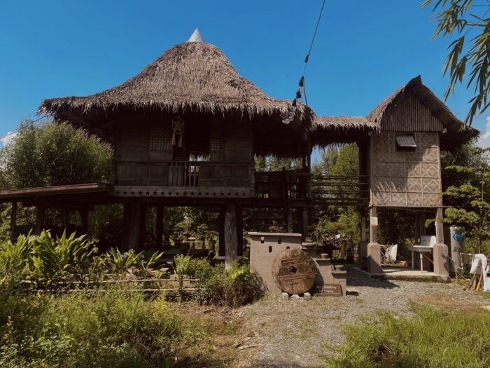 “Silid ng Buhay.” — Filipino nipa houses on stilts, an example of traditional Filipino architecture, in the cultural attraction