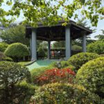 “The gazebo in the maze area, tucked behind sculpted shrubs and bright flowers, offers a place to rest and enjoy the view.”