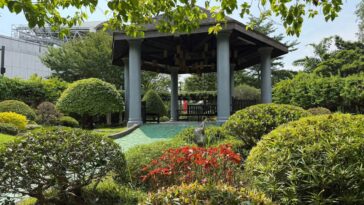 “The gazebo in the maze area, tucked behind sculpted shrubs and bright flowers, offers a place to rest and enjoy the view.”